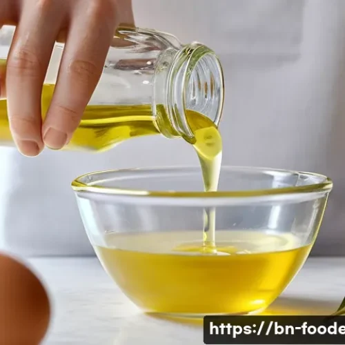 식품에서의 유화 및 분산기술 - **Homemade Mayonnaise Creation in a Bright Kitchen:** A close-up, top-down shot of elegant hands, po...